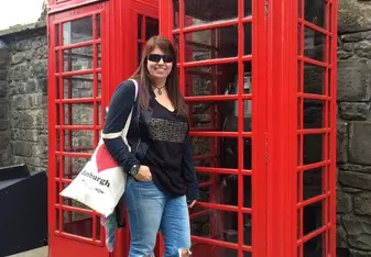 woman at phone booth Edinburgh Castle Scotland