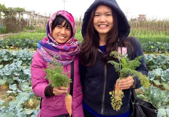 child and girl holding plants in Vietnam