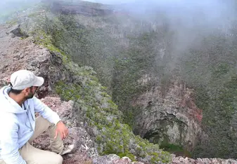 man overlooking foggy canyon