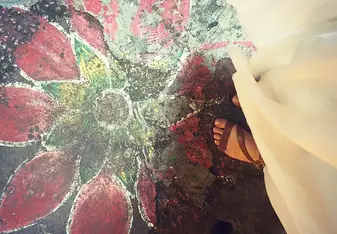 woman standing on floral sidewalk art