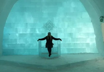woman sitting on chair in ice hotel