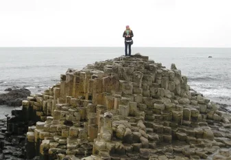 woman standing on Giants Causeway in Northern Ireland