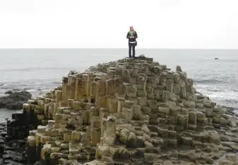 woman standing on Giants Causeway in Northern Ireland