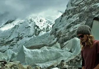 man amongst snowy mountains 