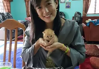 woman holding small kitten