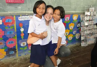 volunteer teacher with young Thai students