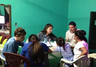 Teaching English to adults in a living room.