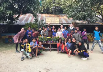 Children posing with their ecological plant pots at the Thanapara Community school
