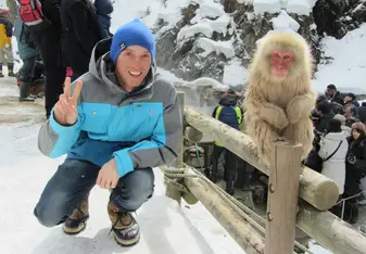 young male skier and snow monkey in Japan