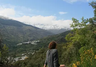 woman on rock with view of mountains
