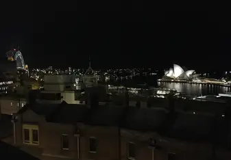 Nighttime view of the Sydney Harbor Bridge (far left) and the Sydney Opera House (far right) 