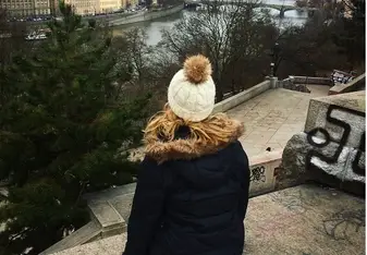 woman on stairs overlooking Prague