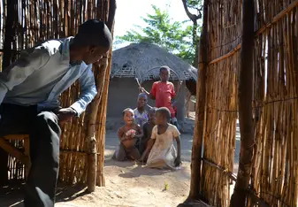 Kalumba wound care - Lovemore (one of the translators) and children waiting to get treated