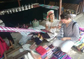 women in shop selling scarves