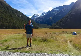 young man standing in mountains