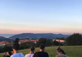 young people on hill at sunset