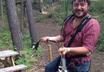 man wearing harness in forest