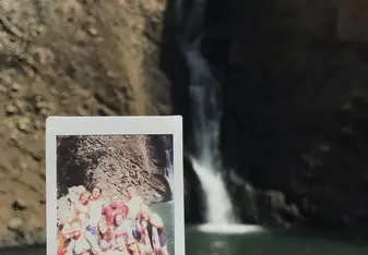 photo of waterfall and polaroid of group