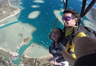 skydivers over water