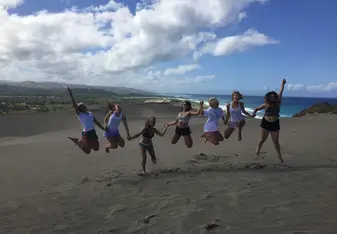 girls jumping on beach