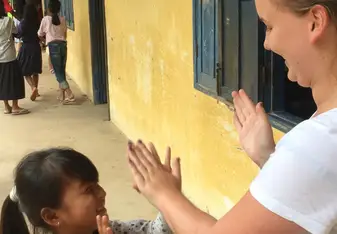 women playing with child in Cambodia