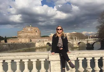 girl sitting on bridge in Europe