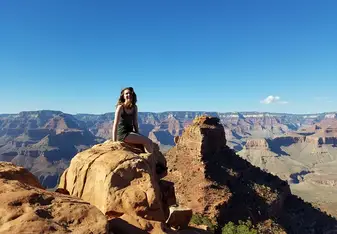 woman on rock in mountains