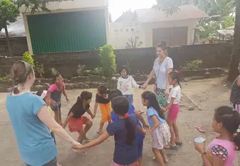 children in Bali playing with volunteers