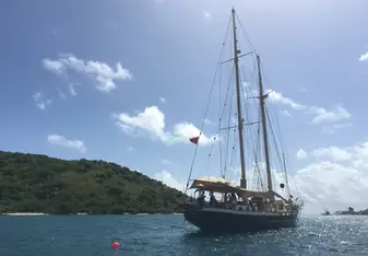 An external view of the ship while doing some sailing on a smaller vessel.