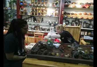 girls sitting at table in shop