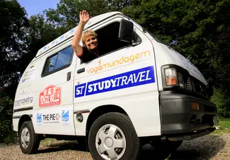 Staff member waves from van in Normandy, France