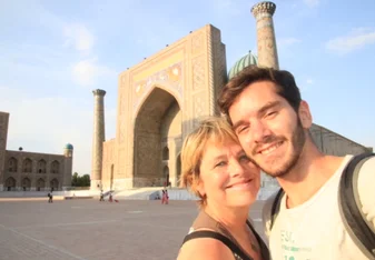 Couple posts in front of monument in Normandy, France