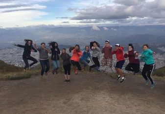 group jumping at sunset