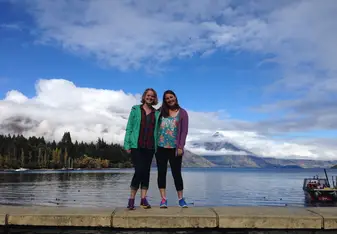 two girls standing on barrier