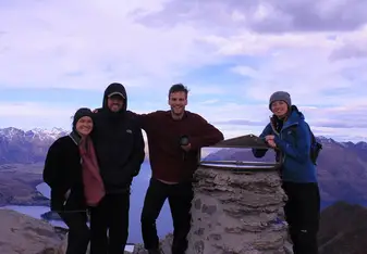 at the top of Ben Lomond, Queenstown, on a road trip with international friends