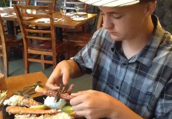 young boy in restaurant eating lunch