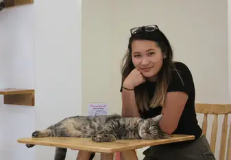 portrait of girl and cat on desk
