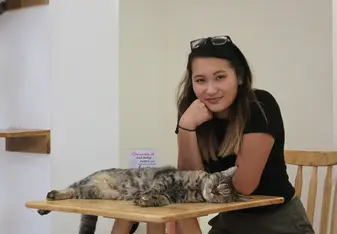 portrait of girl and cat on desk