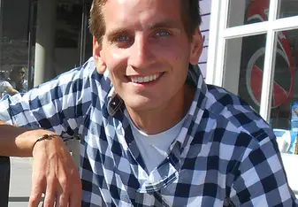 Devin Graves from Foundation for Sustainable Development smiles for a photo at work