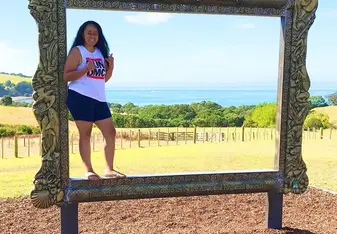 standing in life-size picture frame at Shakespear Regional Park