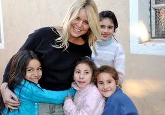 Female volunteer with children in a care project in Argentina