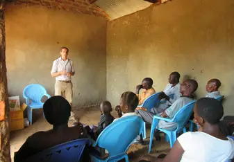 Devin Graves speaks to students while working with Foundation for Sustainable Development 