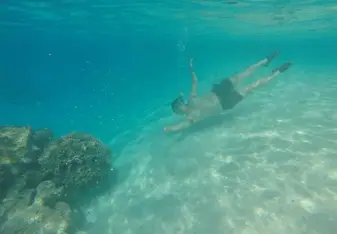 man swimming under water