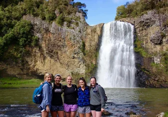group photo by waterfall