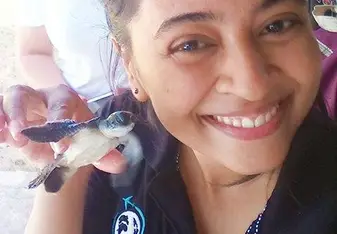 woman holding baby turtle