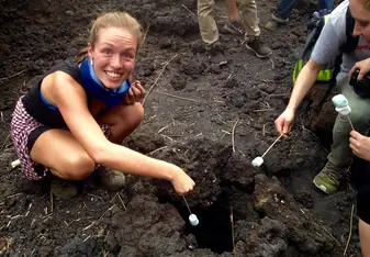 woman smiling in soil with a marshmallow 