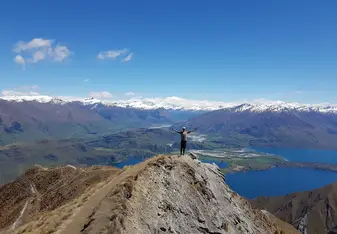 man standing on top of mountain