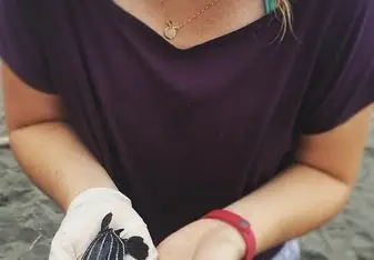 girl holding sea turtle