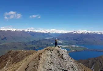man standing on top of mountain
