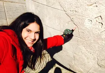 woman pointing to stone map